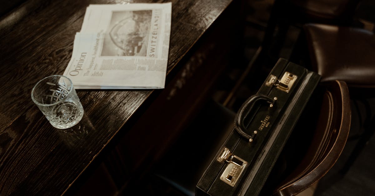 top view of a briefcase glass and newspaper in a rustic indoor setting ideal for business themes 1