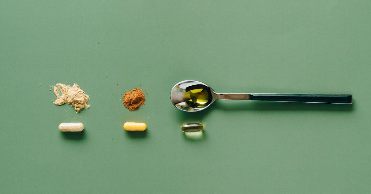 top view of various supplements and powders on a green surface with a spoon