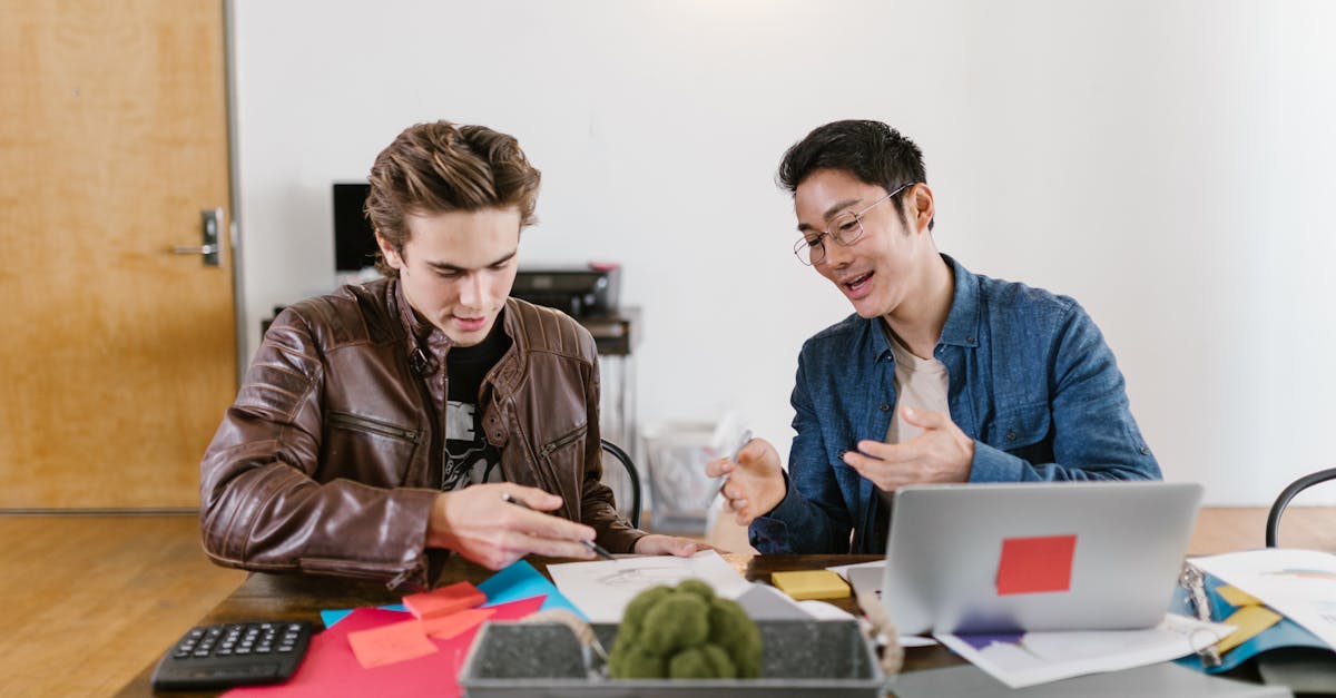 two business professionals discuss ideas and strategies in an office setting fostering innovation a