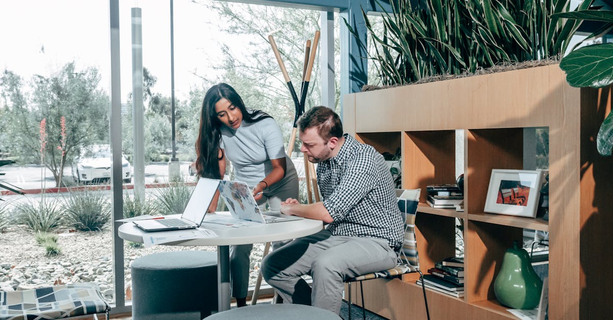 two colleagues engaging in a project meeting in a modern office space with natural light