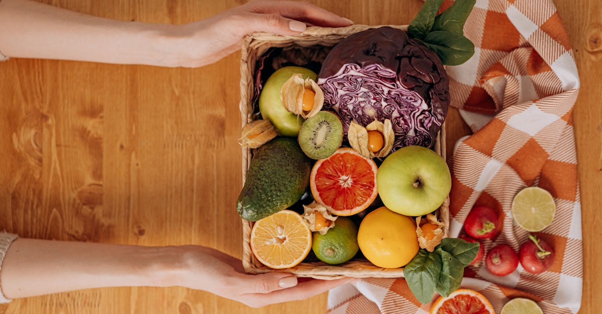 vibrant basket of fresh fruits and vegetables with hands holding on a wooden table