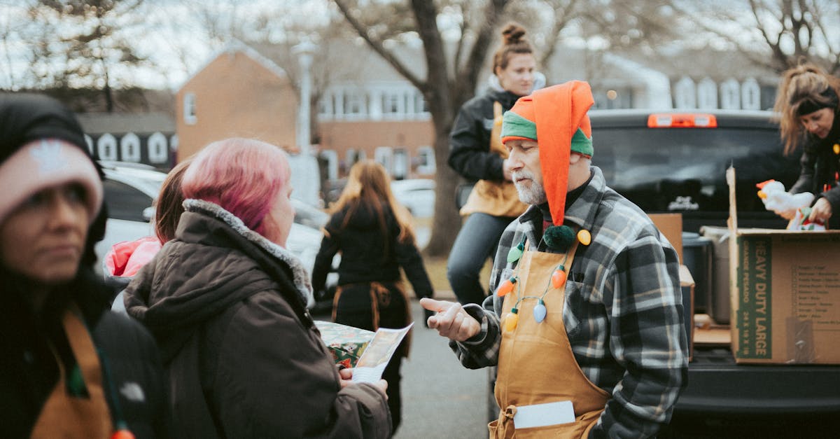 volunteers hand out gifts during a community christmas celebration outdoors