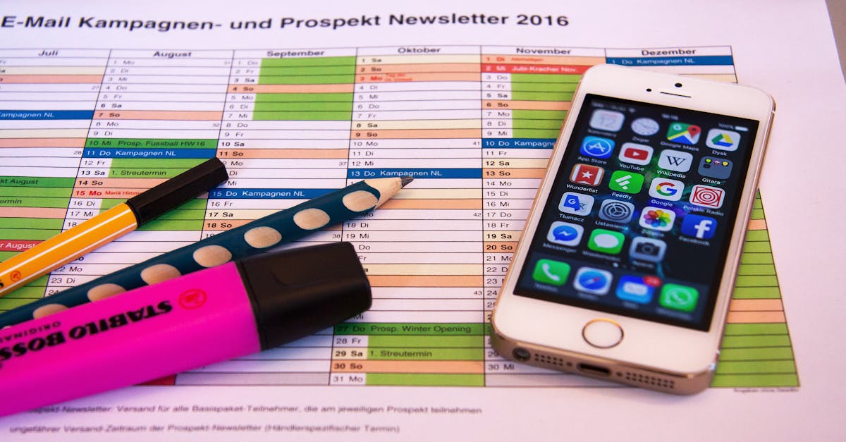 a desk setup featuring a planner pens and a smartphone displaying app icons ideal for productivit 2