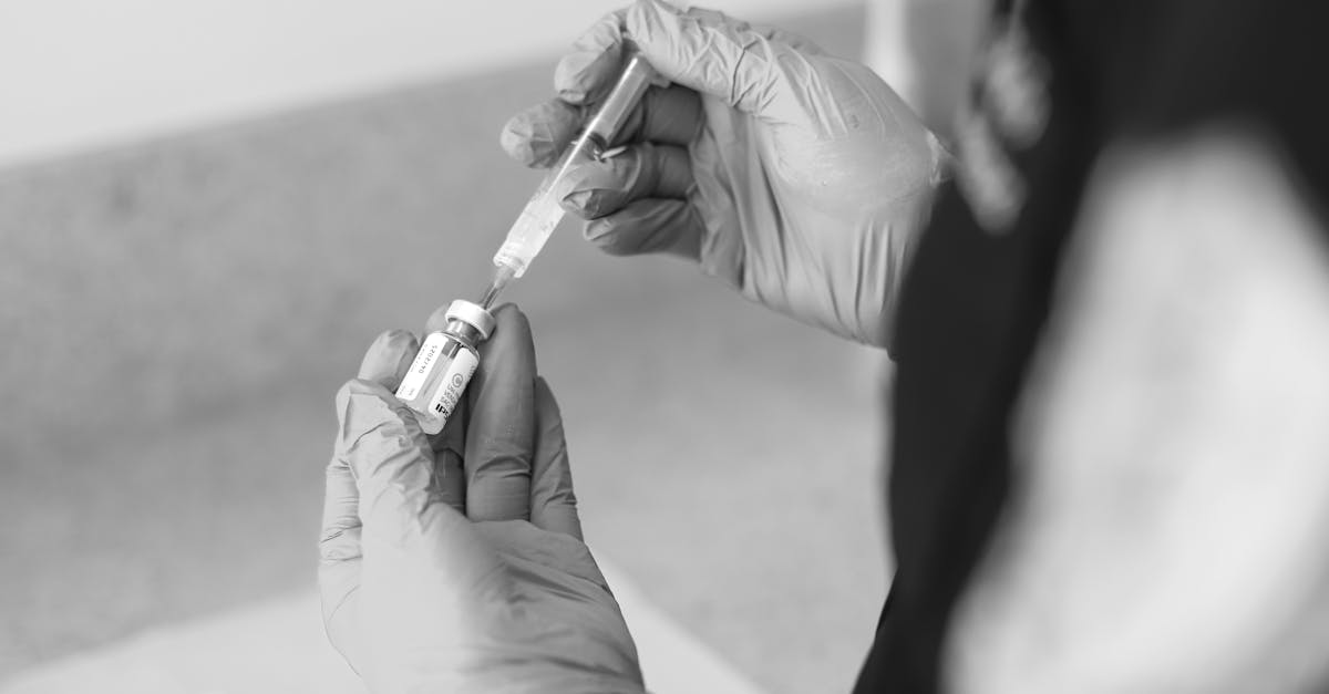 a healthcare worker prepares a syringe with medication in a clinical setting