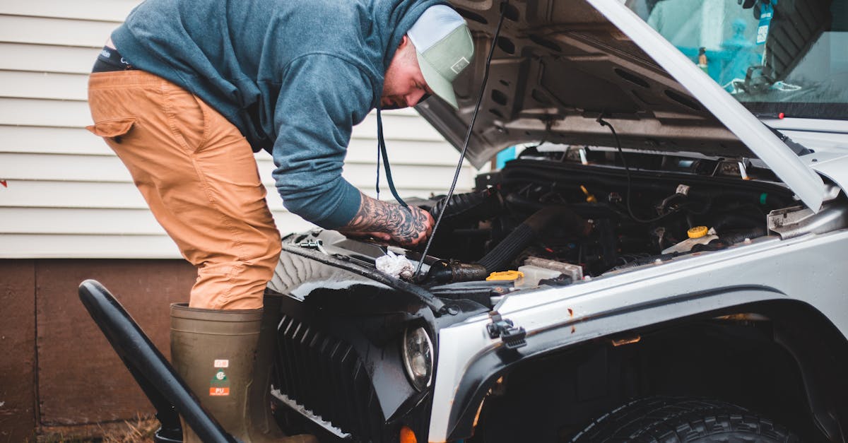 a man inspects and repairs a car engine outside showcasing automotive maintenance and repair skills