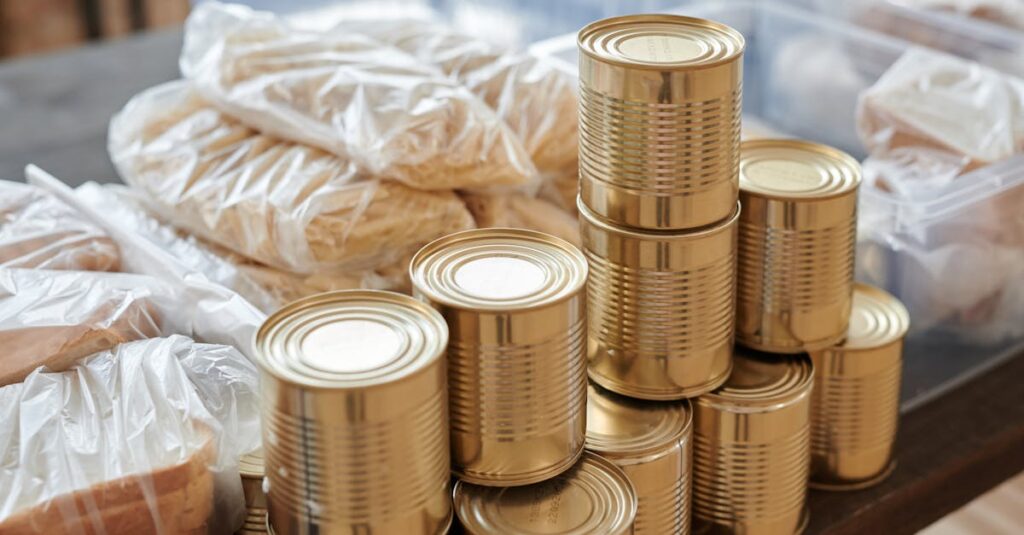 a stack of canned goods and packaged foods on a table perfect for donation drives