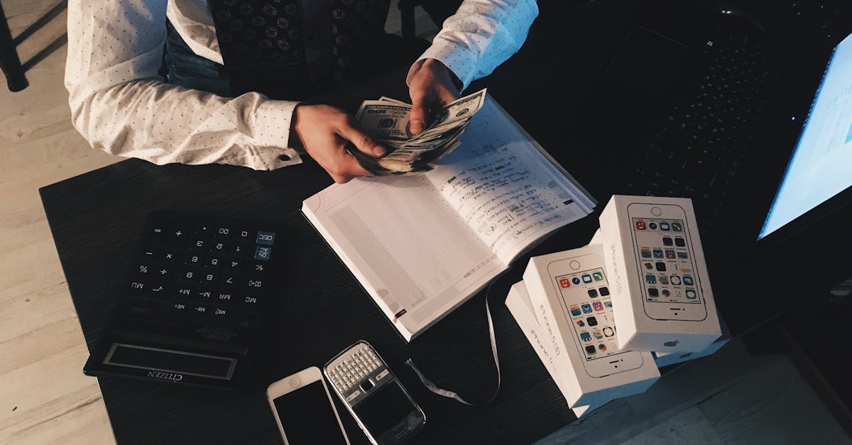 businessman organizing finances with tech devices and cash on desk 2