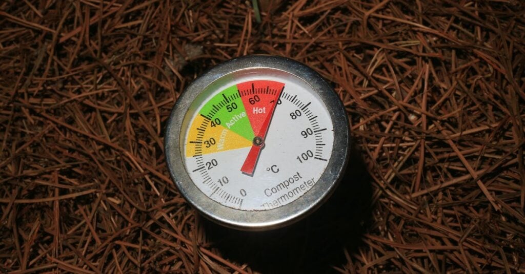 close up of a compost thermometer in soil temperature in active range