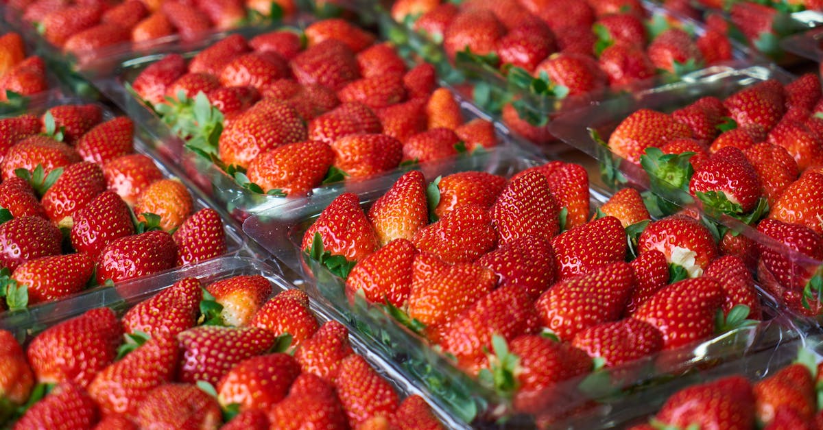 close up of fresh juicy strawberries packed in transparent containers showcasing their vibrant red 1