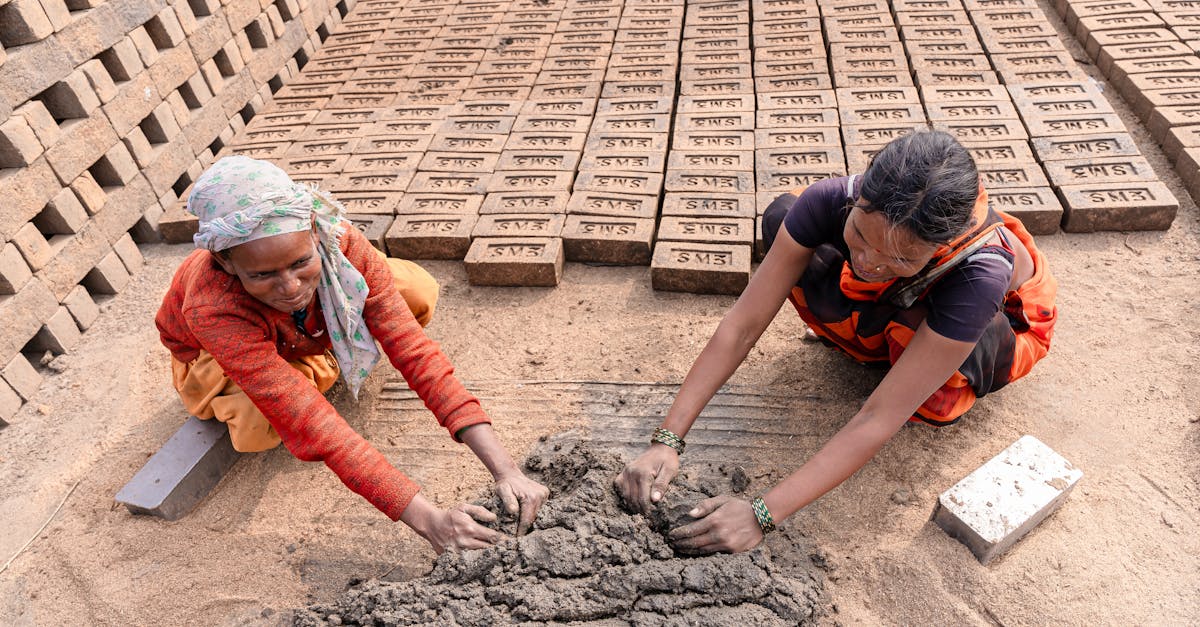 indian women engaged in traditional brickmaking in a rural setting