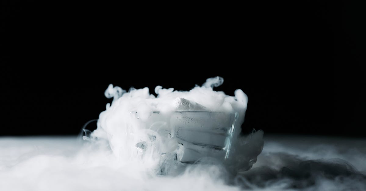 mystical swirling vapor emanating from dry ice in a glass on a black background