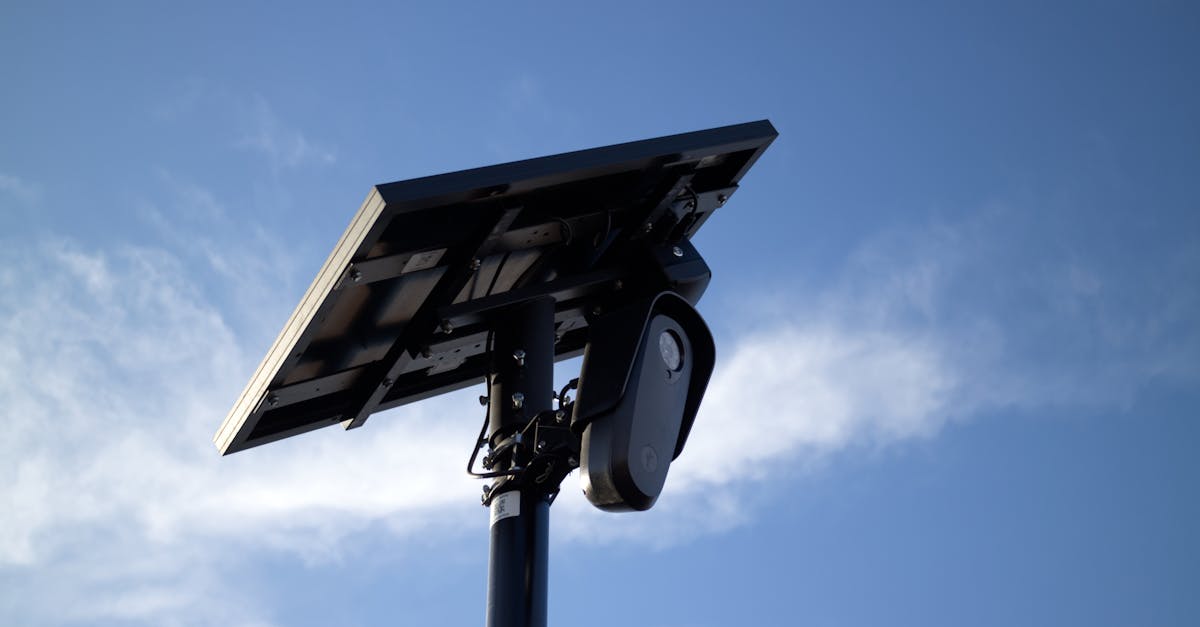 solar powered cctv camera mounted on pole with bright sky background symbolizing security and techn