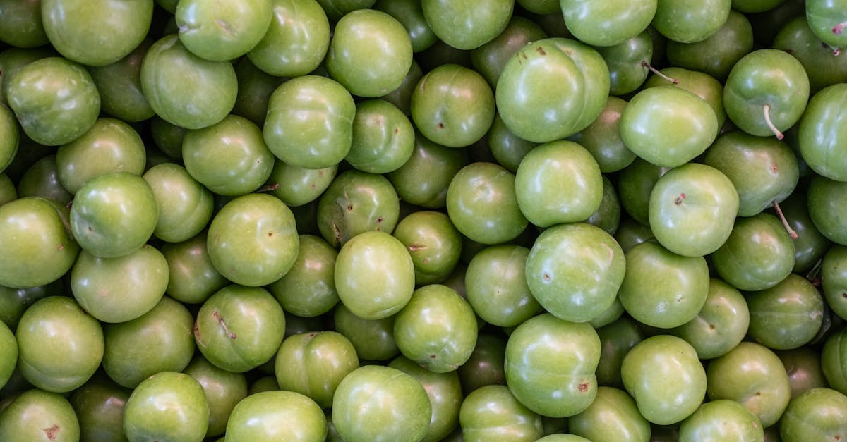 vibrant pile of fresh green plums on display at bornova market