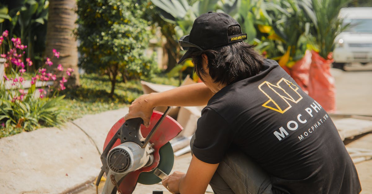 a carpenter uses a circular saw outdoors surrounded by lush greenery in ho chi minh city