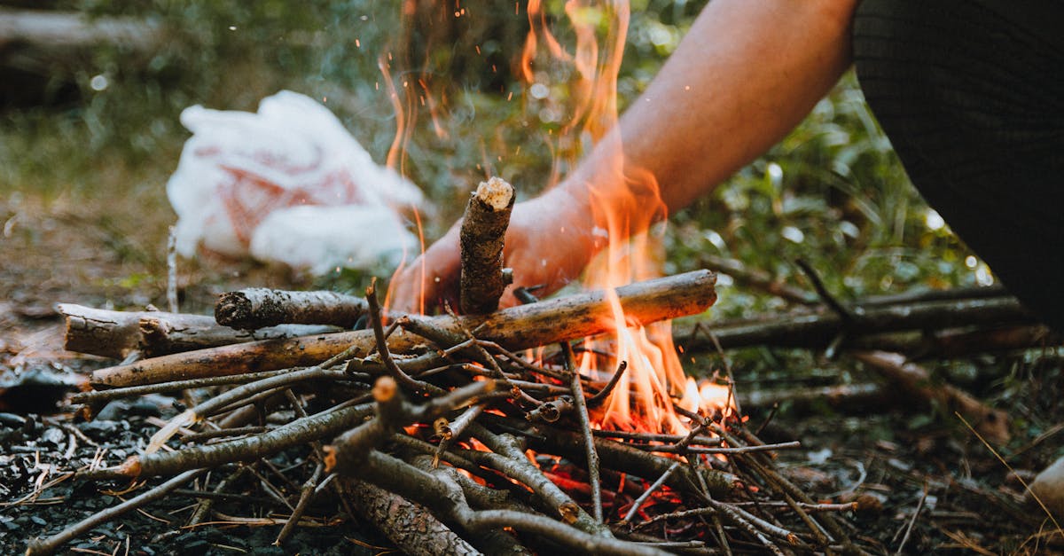 a close up of a campfire with burning sticks perfect for outdoor camping themes
