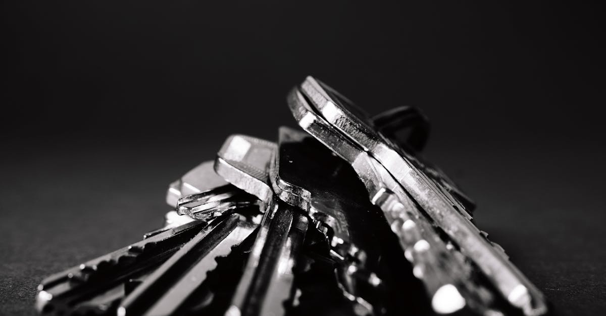 a close up shot of a pile of metallic keys on a dark surface emphasizing security and precision