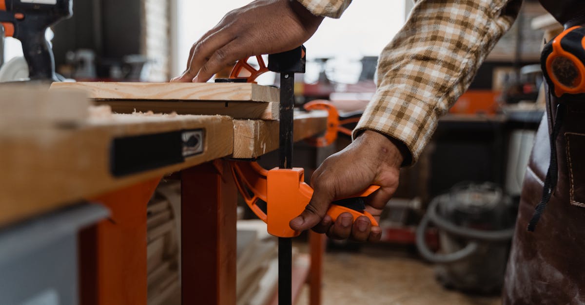 a craftsman skillfully clamps wood in a workshop filled with tools showcasing fine woodworking tech