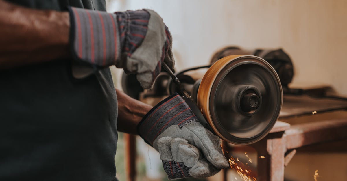 a craftsman using a grinder with sparks flying indoors showcasing skill and precision