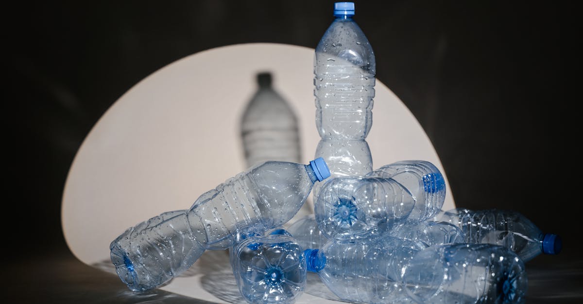 a group of used plastic bottles illuminated under a dramatic spotlight setting 1