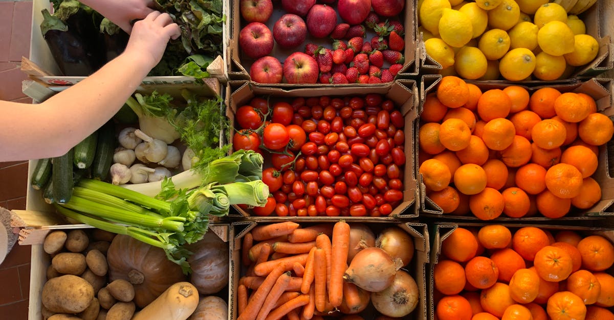 a variety of fresh fruits and vegetables in boxes perfect for a healthy market scene