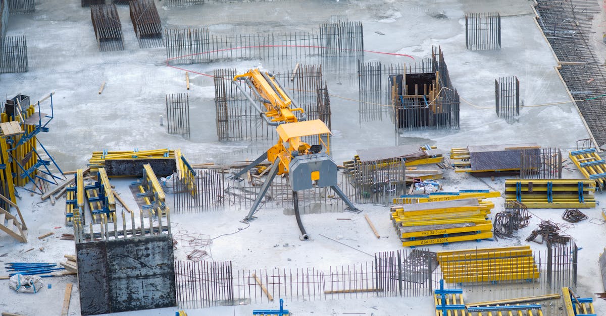 aerial view of an active construction site with heavy machinery and building materials