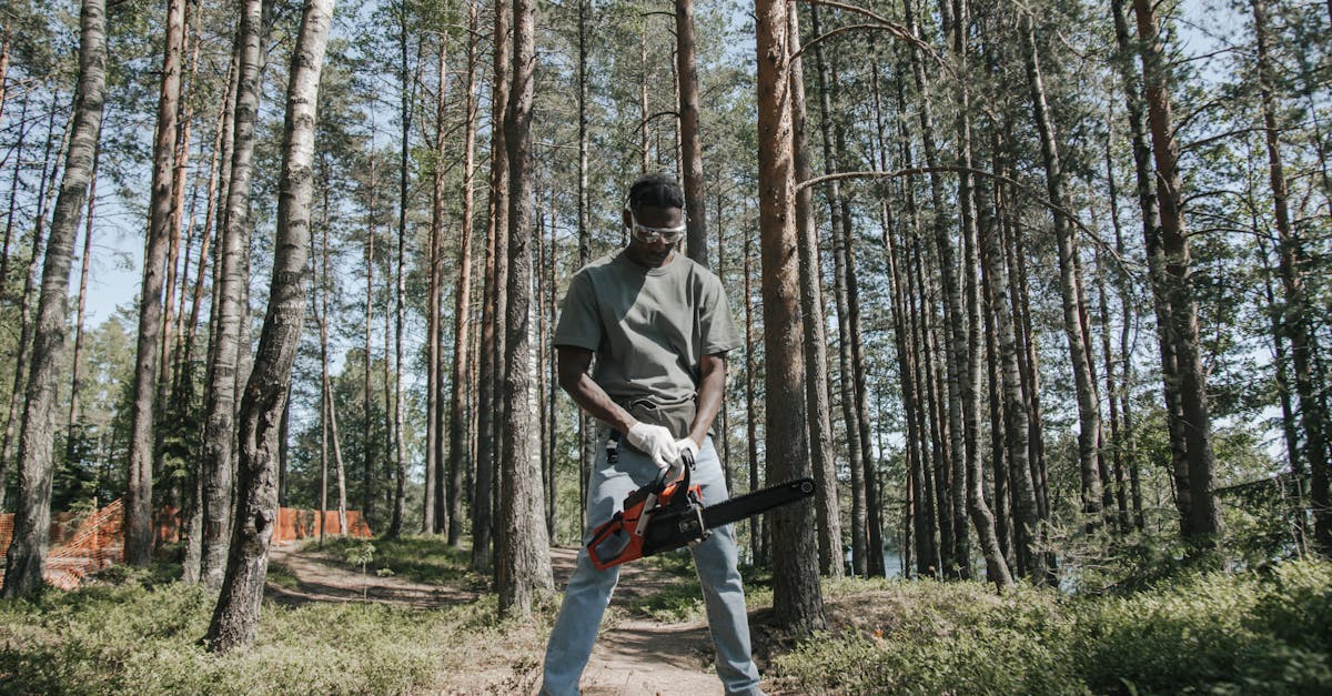 african american man operating a chainsaw in a forest setting 1