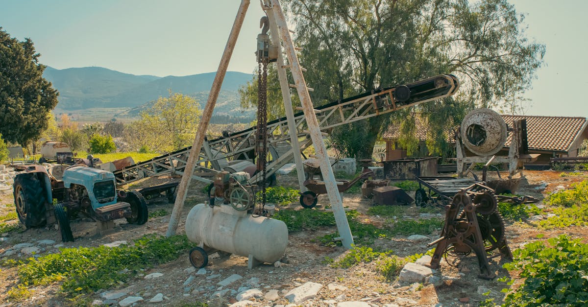 an abandoned farm featuring vintage machinery and equipment in a rural countryside setting