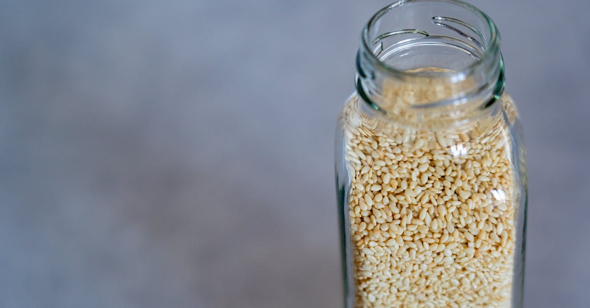 close up of a glass jar filled with sesame seeds perfect for food photography and healthy lifestyle