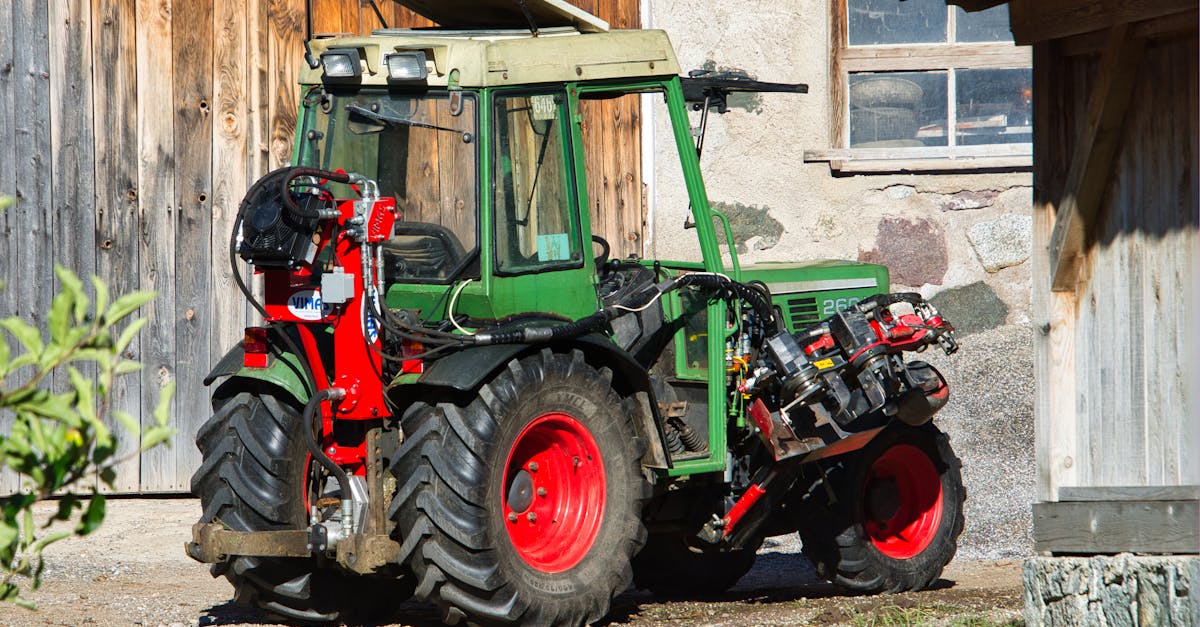 close up of a green tractor parked on a sunny farmyard in schenna trentino sudtirol