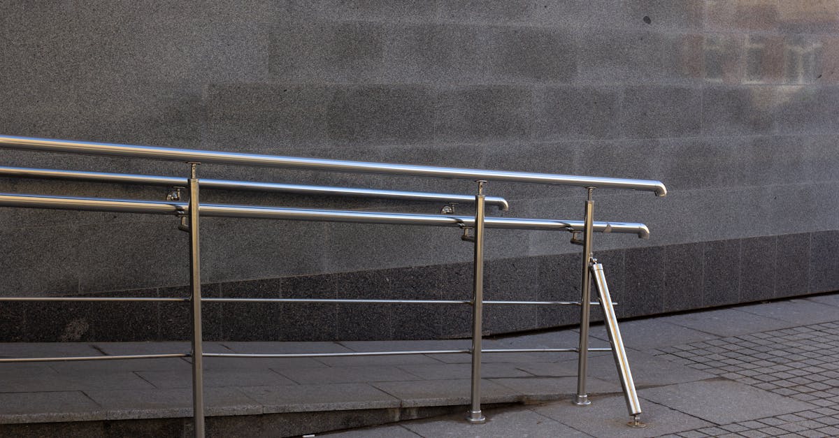 close up of a metal handrail and concrete ramp for accessibility in an urban setting