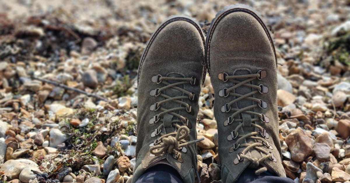close up of hiking boots resting on a rocky ground ideal for outdoor or hiking themes
