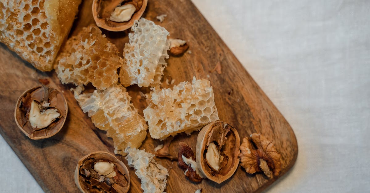 close up of honeycomb and walnuts on a rustic wooden board top view
