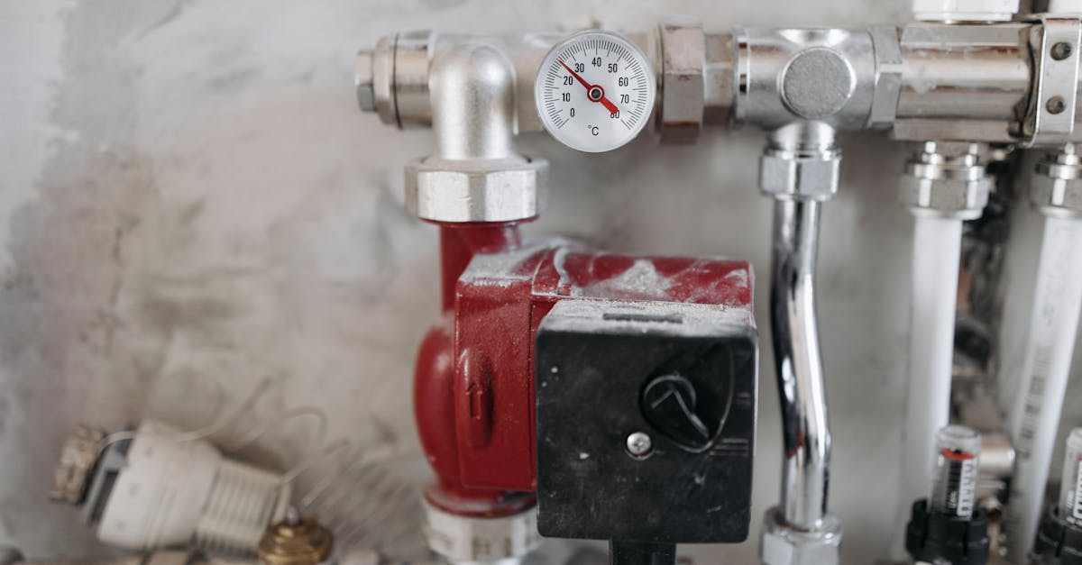 close up view of an industrial plumbing system featuring a pressure gauge and steel pipes 1