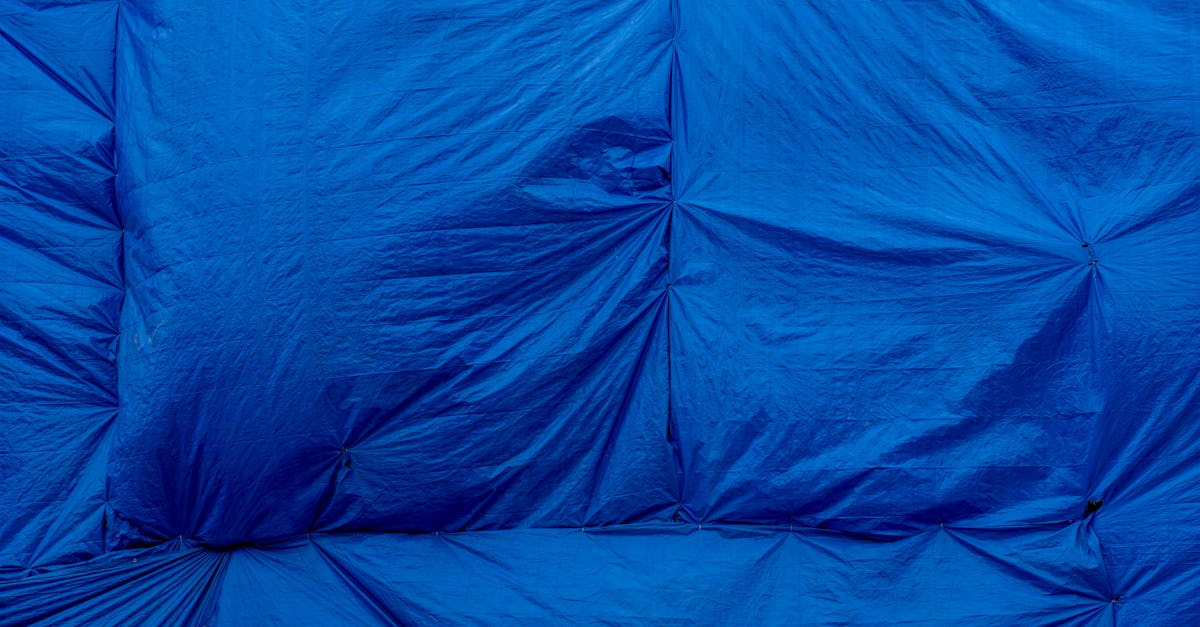 detailed close up of a blue tarp showing textured surface and folds