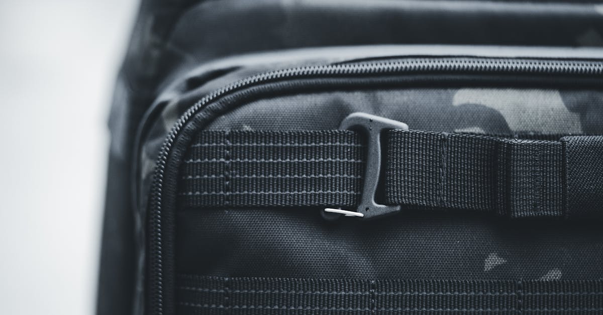 detailed shot of a black tactical backpack highlighting the buckle and fabric texture ideal for tra