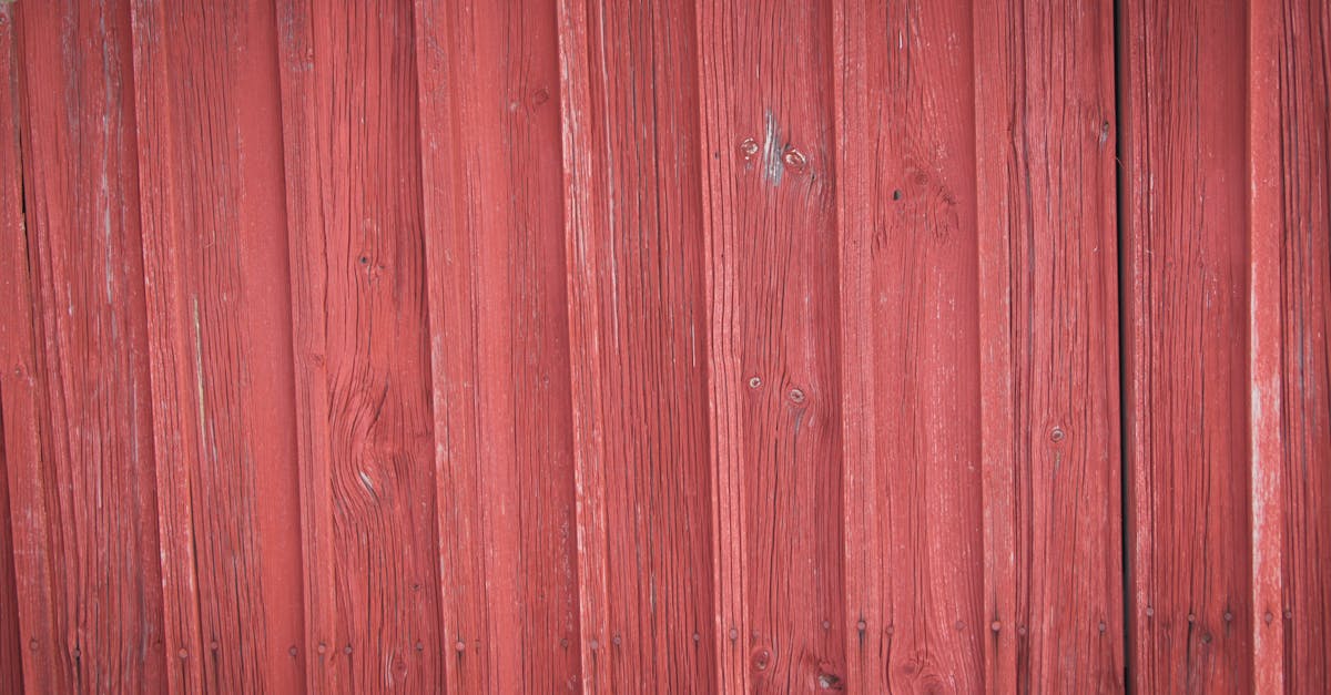 detailed view of a rustic red painted wooden wall showing natural grain and