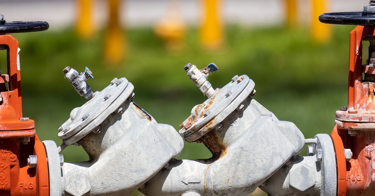 detailed view of rusted industrial gas valves outdoors on a sunny day