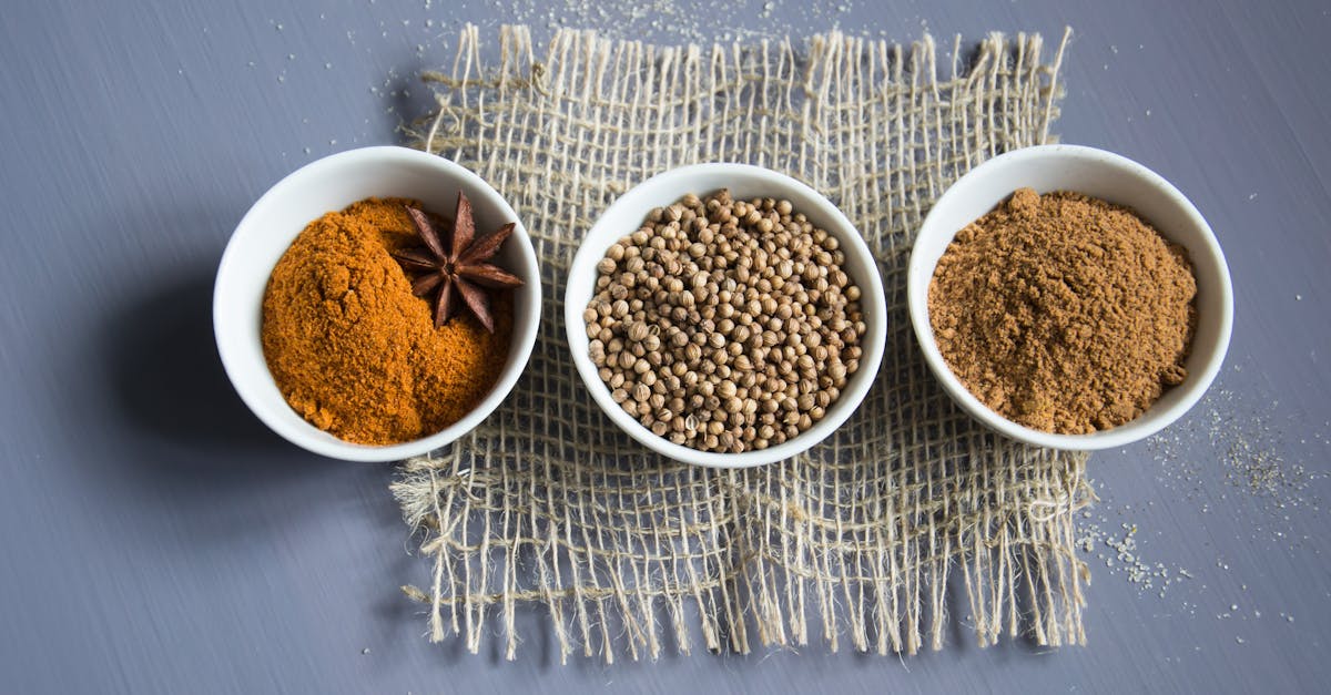 flat lay of aromatic spices in bowls on a textured mat 2