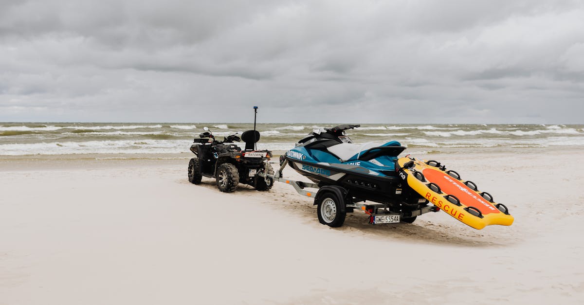 jet ski and quad bike with rescue equipment on a cloudy beach shore