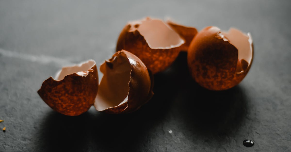 macro shot of broken brown eggshells on a dark backdrop perfect for culinary themes
