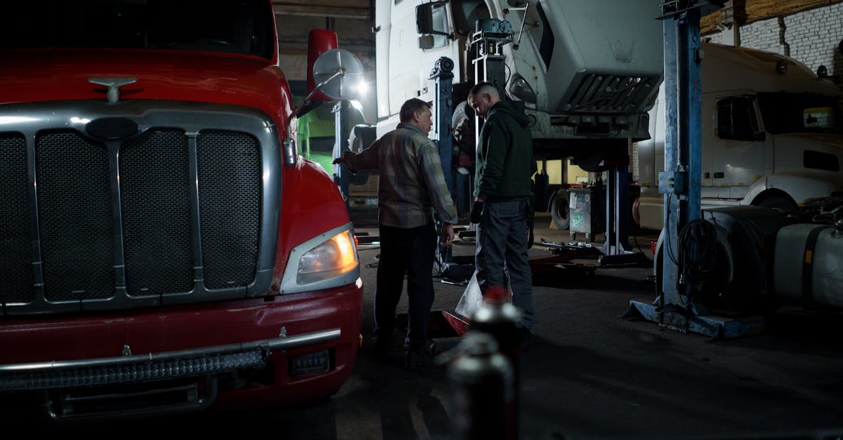 mechanics performing truck maintenance and repair in an indoor garage setting 13