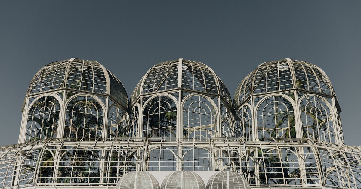 modern greenhouse with steel and glass structure against a clear sky iconic architectural design