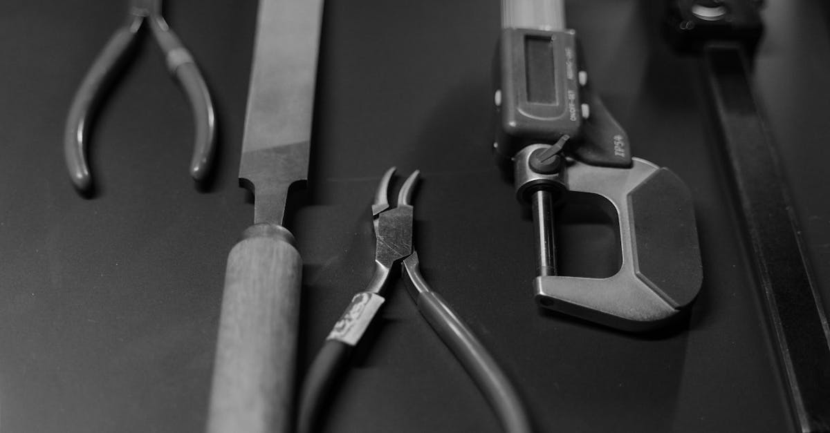 monochrome image featuring various workshop tools arranged neatly on a surface