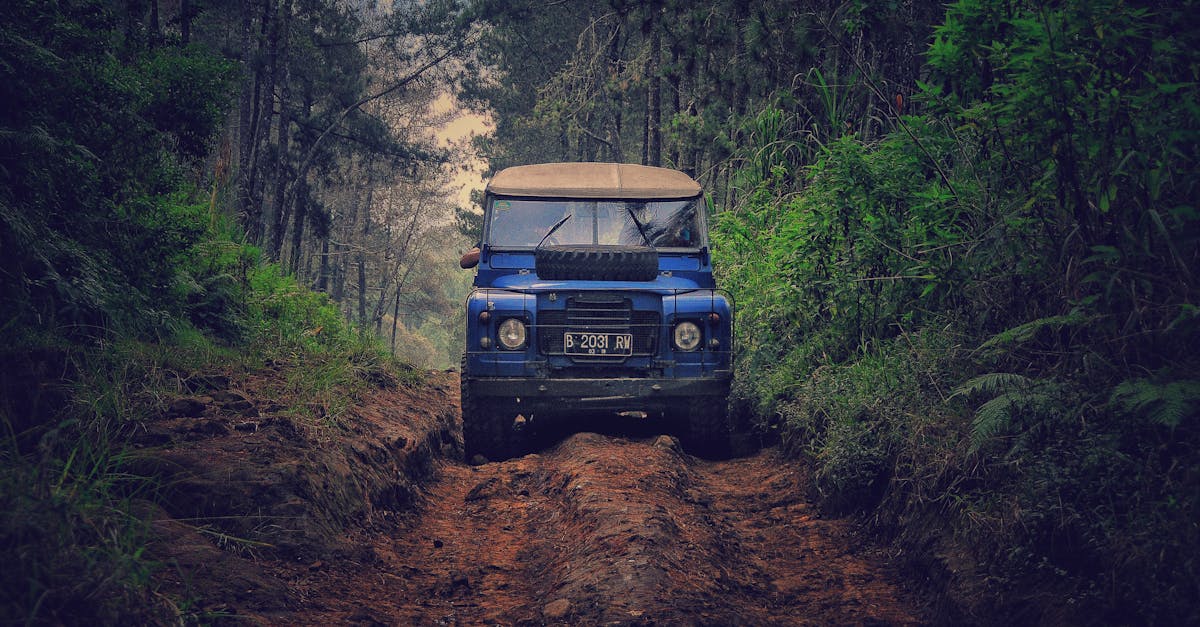 off road vehicle traversing a rugged dirt path through lush forest in parongpong indonesia