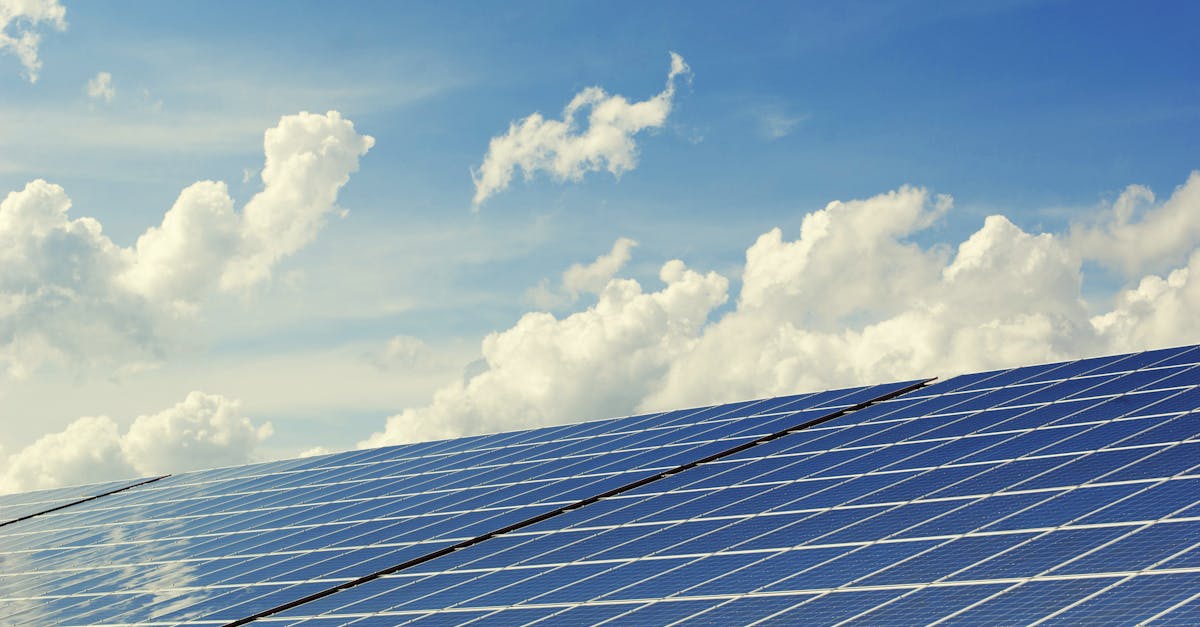 sleek modern solar panels under a vibrant blue sky with clouds symbolizing clean energy