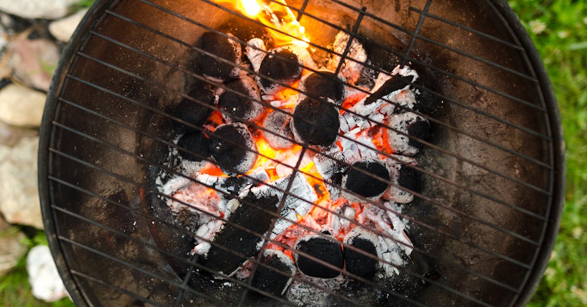 top view of a charcoal grill with orange glowing embers and flames ready for outdoor cooking