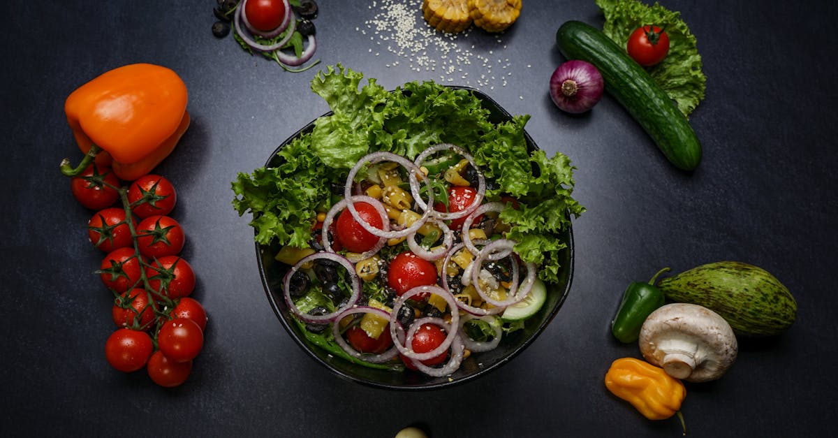 top view of a fresh vegetable salad surrounded by various colorful ingredients