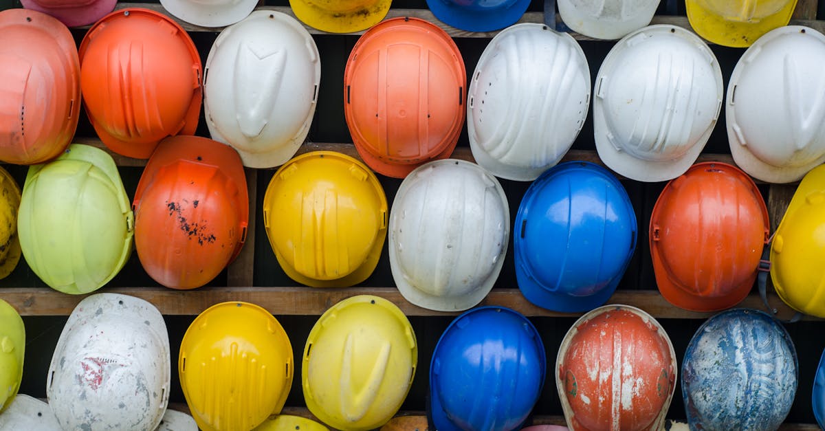 vibrant collection of industrial safety helmets neatly arranged on a wall